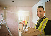 Portrait construction worker plastering