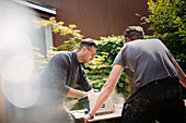 Construction workers using table saw