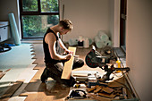 Construction worker preparing hardwood flooring