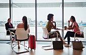 Businesswomen talking in airport business lounge