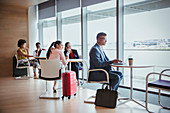 Business people working in airport business lounge