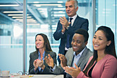 Business people and clapping in meeting