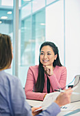 Businesswoman listening to colleague in meeting