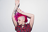 Young woman with pink mohawk dancing