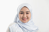Young woman wearing blue silk hijab