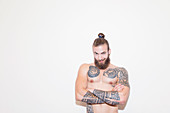 Portrait male hipster with bare chest and tattoos
