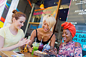 Young women friends enjoying smoothies