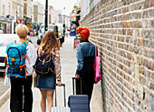 Young women friends with suitcases and backpack