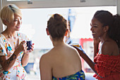 Young women friends drinking coffee and talking