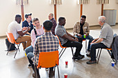 Men talking in group therapy in community centre