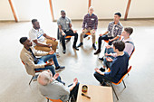 Men praying in circle in prayer group