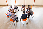 Men praying in circle in prayer group