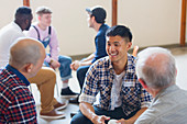 Men talking and listening in group therapy