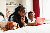 Grandmother and grandson using digital tablet