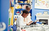 Mother reading bedtime story to son