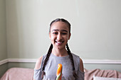 Portrait tween girl eating flavoured ice