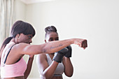 Mother teaching daughter boxing