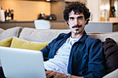 Portrait man using laptop