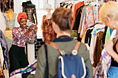 Young woman photographing friends shopping