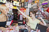 Enthusiastic friends cheering in bar