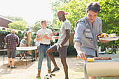 Male friends enjoying backyard barbecue