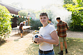 Portrait teenage boy with soccer ball