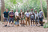 Portrait men's group hikers standing in a row in woods