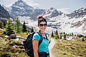 Portrait hiker on sunny, idyllic mountain trail, Canada