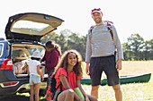 Portrait father and daughter camping, unloading car