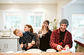 Portrait happy, playful family baking