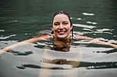 Portrait woman swimming in lake