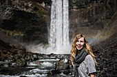 Portrait woman hiking along waterfall, Canada