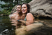 Affectionate couple swimming in lake