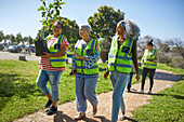 Female volunteers planting tree in park