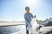 Boy volunteer cleaning up litter