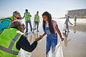 Grandparent and granddaughter volunteers cleaning up litter
