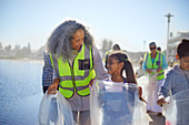 Grandmother and granddaughter volunteers picking up litter