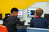 Junior high boy students using computers