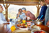 Couple hugging, enjoying healthy breakfast in hut
