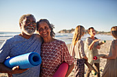 Portrait senior couple with yoga mats