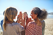 friends with hands clasped in circle