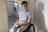 Smiling woman in wheelchair at home