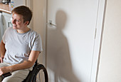Smiling woman in wheelchair at home