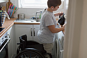 Young woman with wheelchair pouring tea