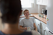 Young woman in wheelchair drinking tea