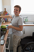 Portrait woman with wheelchair cooking