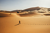 Man walking in desert, Sahara, Morocco