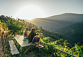 Couple enjoying hillside view, Chas de Egua, Portugal