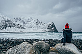Woman in warm clothing enjoying mountain view, Norway