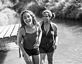 Portrait mother and daughter swimming in river